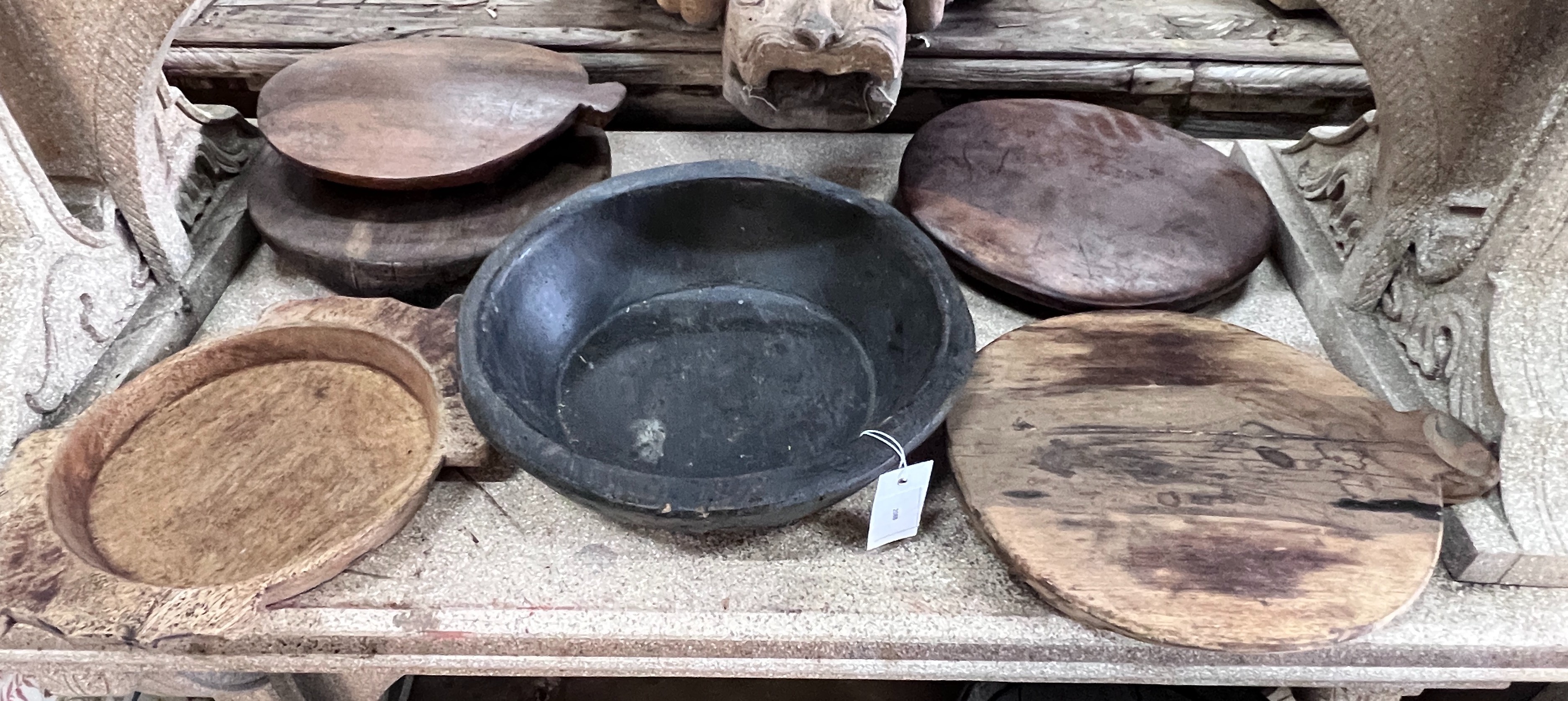 Two wood mazers and five wood trivets, largest diameter 38cm